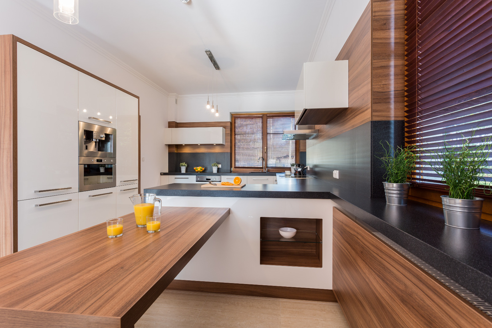 Modern kitchen after Worktop Refinishing in Hounslow, with walnut solid wood worktops and a light ceramic tile kitchen floor.